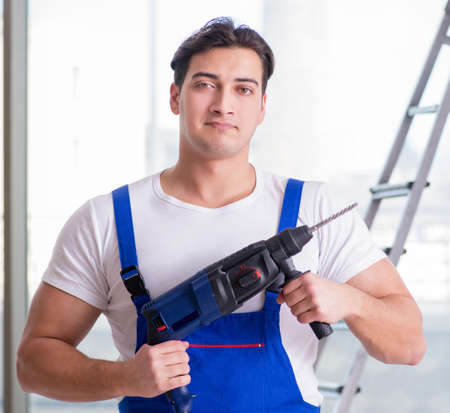 Young worker with hand drillの写真素材