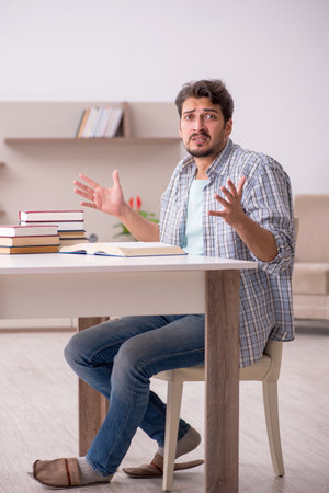Young male student preparing for exams at homeの写真素材