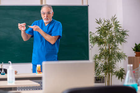 Old male doctor dentist in the classroomの写真素材
