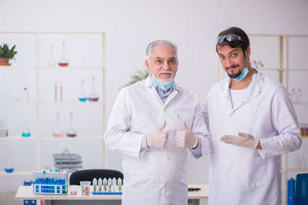 Two male chemists in drugs synthesis concept at the labの写真素材