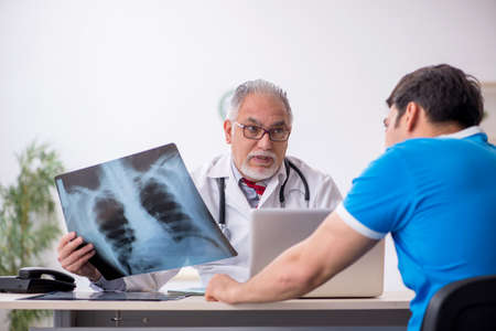 Young male patient visiting old male doctor radiologist