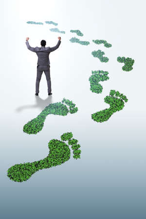 Ecology concept with green footprint and businessmanの写真素材