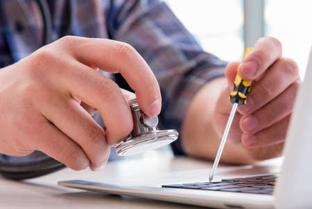 Computer repairman repairing computer laptop