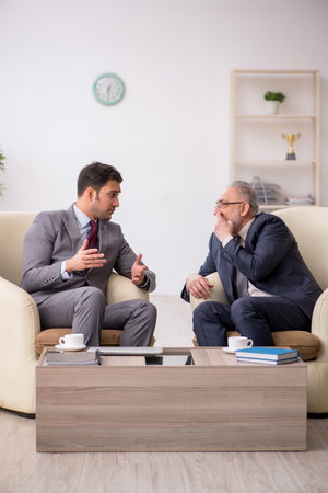 Two businessmen discussing project at workplaceの写真素材