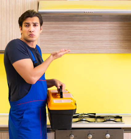 Young service contractor assembling kitchen furnitureの写真素材