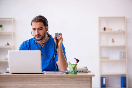 Young male doctor in telemedicine conceptの写真素材