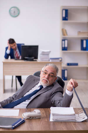 Two male employees working in the officeの写真素材