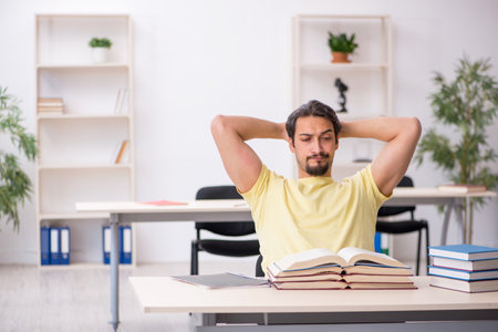 Young male student preparing for exams in the classroomの写真素材
