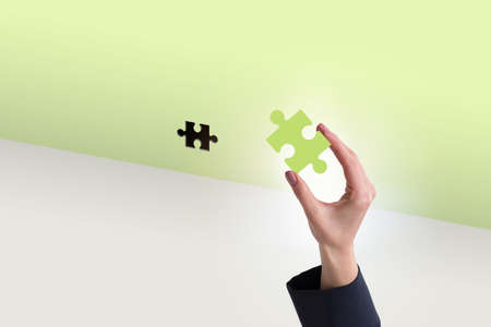 Businessman putting missing jigsaw puzzle pieceの写真素材
