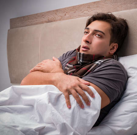 Sick man resting in the bedの写真素材