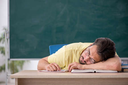 Young male student preparing for exams in the classroomの写真素材