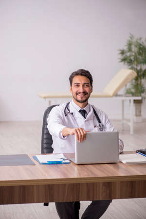 Young male doctor in telemedicine conceptの写真素材