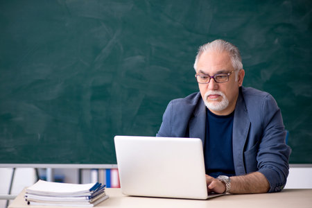 Old male teacher in tele-education conceptの写真素材