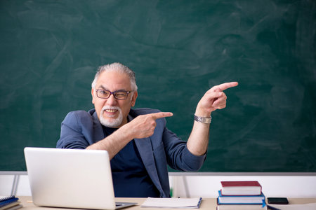 Old male teacher in the classroomの写真素材