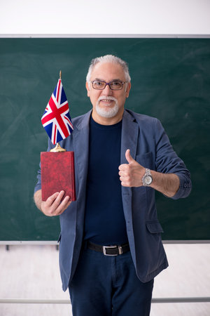 Old male english language teacher in the classroomの写真素材