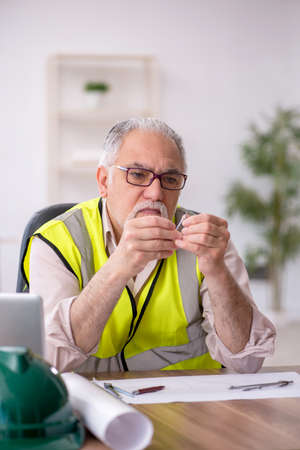 Old male architect working in the officeの写真素材