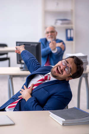 Two male colleagues working in the officeの写真素材