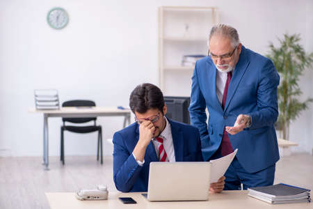 Two male colleagues working in the officeの写真素材