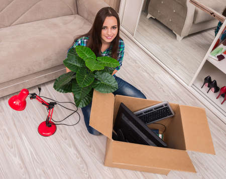 Young woman packing personal belongings