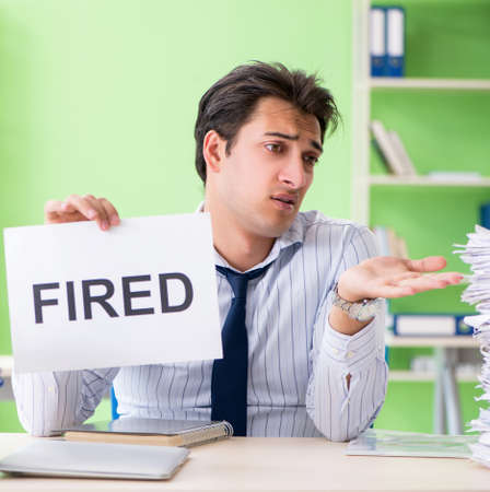 Businessman having problems with paperwork and workloadの写真素材