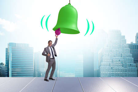 Businessman ringing the bell in case of danger
