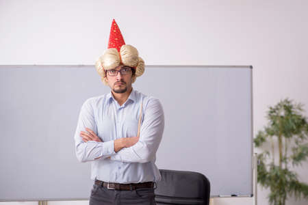 Funny young male teacher magician in the classroomの写真素材