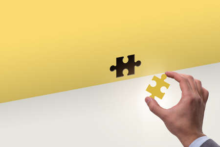 Businessman putting missing jigsaw puzzle pieceの写真素材
