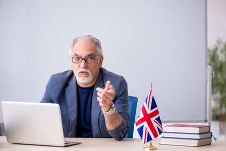 Old male english language teacher in the classroomの写真素材