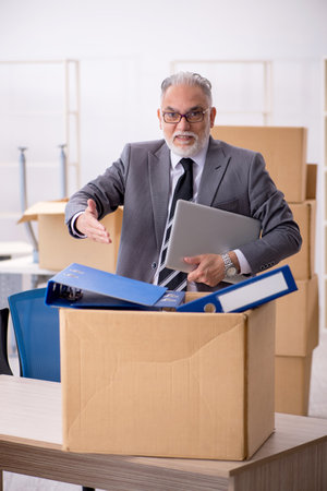 Old male employee in relocation conceptの写真素材