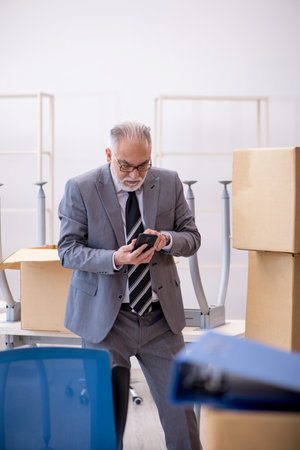 Old male employee in relocation conceptの写真素材