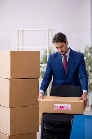 Young male employee in relocation conceptの写真素材