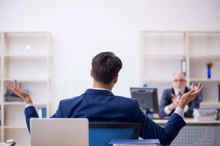 Two male colleagues working in the officeの写真素材