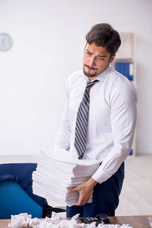 Young male employee in brainstorming conceptの写真素材