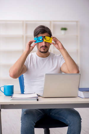 Young male employee in e-commerce conceptの写真素材
