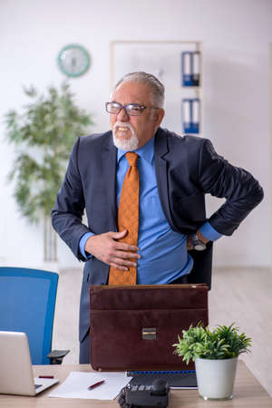 Old boss working in the officeの写真素材