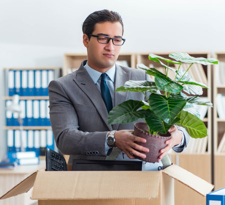 Man moving office with box and his belongingsの写真素材