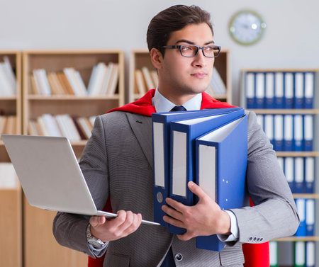 Superhero businessman working in the officeの写真素材