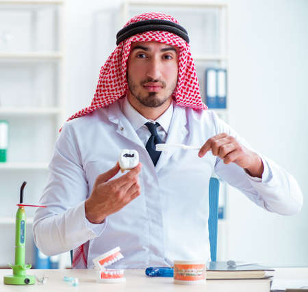 Arab dentist working on new teeth implantの写真素材
