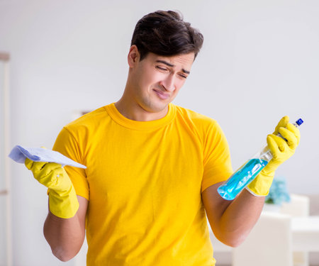 Man husband cleaning the house helping his wifeの写真素材