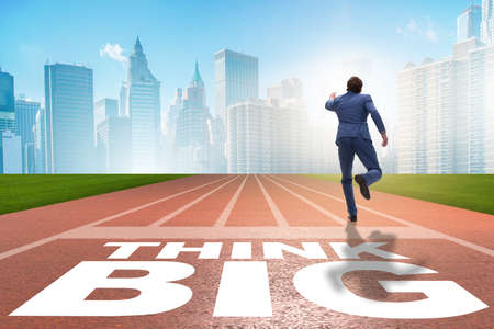 Businessman in think big concept on running track
