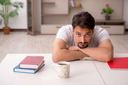 Young male student studying at home during pandemicの写真素材