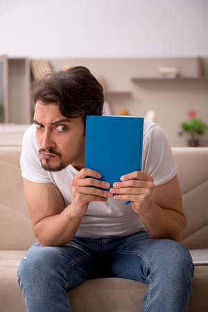 Young male student studying at home during pandemicの写真素材