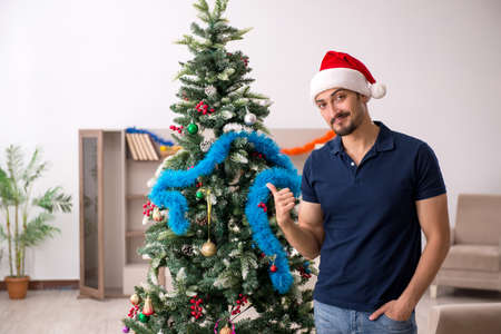 Young man celebrating Christmas at homeの写真素材