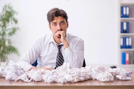 Young male employee in brainstorming conceptの写真素材