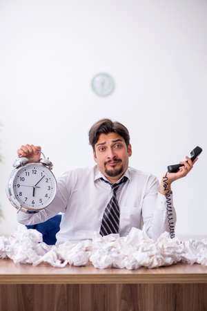 Young male employee in brainstorming conceptの写真素材
