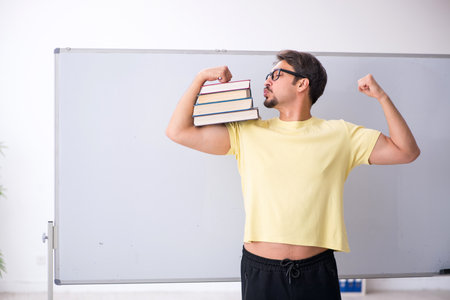 Young male student in front of whiteboardの写真素材