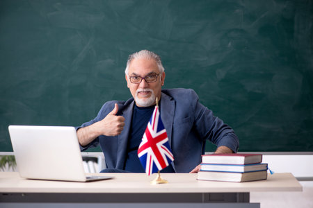 Old male english language teacher in the classroomの写真素材