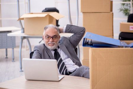 Old male employee in relocation conceptの写真素材