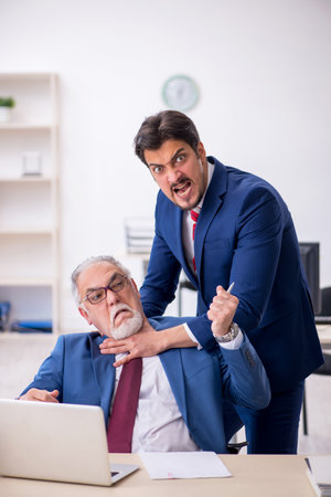 Two male colleagues working in the officeの写真素材