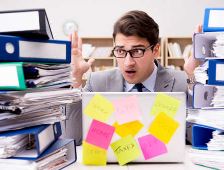 Businessman struggling with multiple prioritiesの写真素材